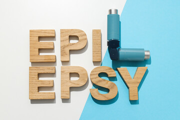 Epilepsy day written in wooden letters with inhalers