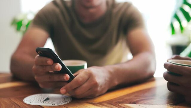 Hands, coffee shop and phone for social media, reading blog and talking of website or information at small business. People, friends or customer typing on mobile for online menu at a startup cafe