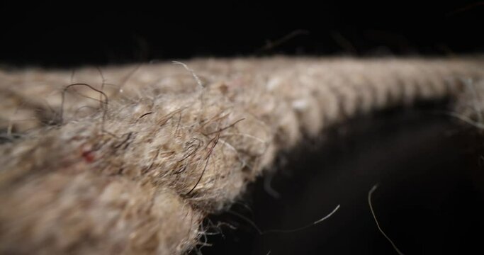 Braided rope extremely closeup on black background. Climbing equipment rope