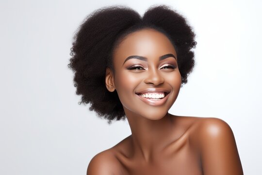 Closeup portrait of beautiful smiling African woman model looking at camera on white background