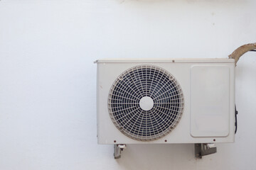 air conditioning condenser unit. Air conditioner on white wall background