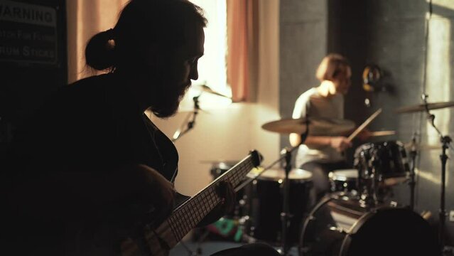 Musicians rehearsing in sound recording studio. Music band repetition.