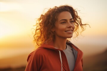A female runner jogging outdoors in the morning against the bright and beautiful morning light