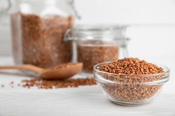 Raw buckwheat in a bowl on a textured wooden background. Wheat grains, porridge, cereals, raw buckwheat in a plate. Healthy food. Porridge. Diet. Organic cerea. Space for text.Copy space.