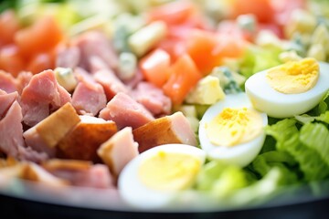 macro shot of diced hard-boiled eggs in a cobb salad