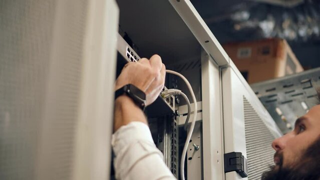 An engineer working on cluster console in an artificial intelligence server room