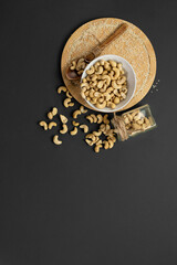 Obraz na płótnie Canvas Flat lay of cashew nuts on a gray background.Copy space.Vertical format
