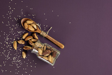 Pecan nuts on a violet background.Copy space.Top view