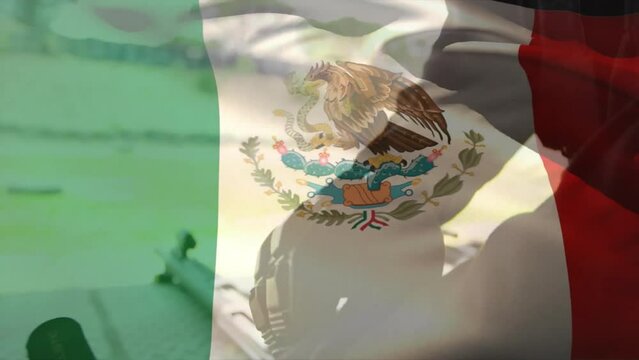 Animation of flag of mexico over caucasian male soldier wearing gloves