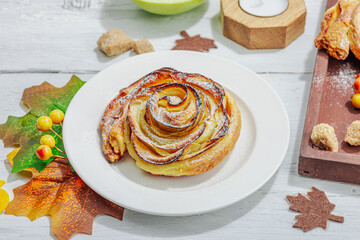 Apple roses pie with sugar powder. Traditional autumn baking, fall decor, flat lay