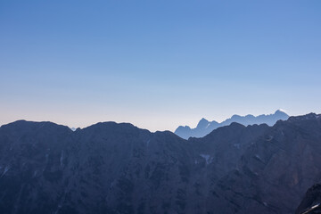 Silhouette of mountain peaks of wild Julian Alps seen on scenic hiking trail to majestic summit Mangart, Friuli Venezia Giulia, border Italy Slovenia, Europe. Hiking wanderlust in alpine wilderness