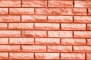 Obraz premium textured brick background in the color of 2024 peach fuzz. High quality photo
