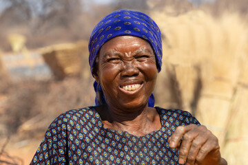 village happy old african woman , outdoors in a sunny day in the bush