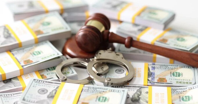 Judge gavel with handcuffs on background of stacks of dollar bills. Judge gavel, dollar bills handcuffs arrest and bail