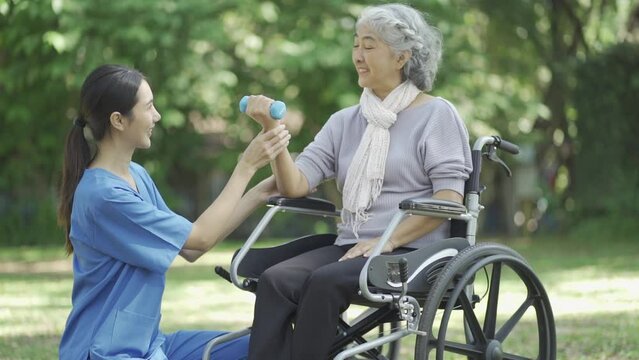 Professional physiotherapist taking care of asian senior patient during rehabilitation.