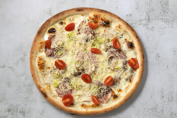 Flat lay italian pizza with cherry tomatoes,chicken breast and bacon.Isolated.
