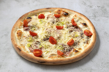 Italian pizza isolated with cherry tomatoes,chicken breast and bacon