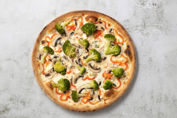 Isolated vegetarian pizza with broccoli,peppers and mushrooms on gray background.Top view vegan food.Free space