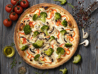 Flat lay vegetarian pizza with broccoli,mushrooms and ingredients.Top view vegan food.
