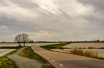 Werkendam, The Netherlands, December 29, 2024: meandering road between bodies of water as part of the Room for the river project in Noordwaard region in Biesbosch national park
