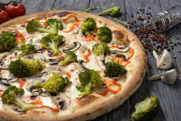 Close up appetizing vegetarian pizza with broccoli and mushrooms and ingredients.Vegan fastfood