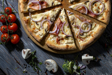 Close up slices of pizza with bacon, chicken, mushrooms and onions