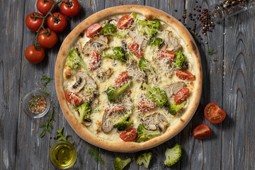 Pizza with broccoli,cherry tomatoes,mushroom,chicken breast.Top view