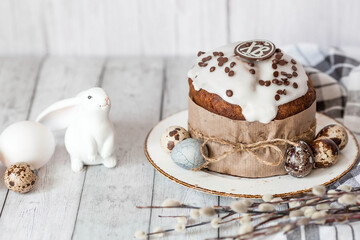 Stylish grey Easter eggs in the colors of marble, concrete, willow branches, Easter bunnies and Easter cake on a white wooden background. Coloring eggs for Easter.  The feast of bright Easter.