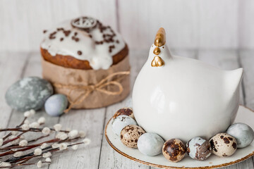 Fototapeta na wymiar Stylish grey Easter eggs in the colors of marble, concrete, willow branches, Easter chicken and Easter cake on a white wooden background. Coloring eggs for Easter. The feast of bright Easter.
