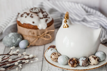 Fototapeta na wymiar Stylish grey Easter eggs in the colors of marble, concrete, willow branches, Easter chicken and Easter cake on a white wooden background. Coloring eggs for Easter. Easter 2024