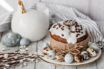 Stylish grey Easter eggs in the colors of marble, concrete, willow branches, Easter chicken and Easter cake on a white wooden background. Coloring eggs for Easter. Easter 2024