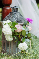 Old vintage lantern decorated with rose, carnation, and lilac flower - 706327705