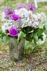 Lilac Peonies, Giant Onions, and Carnations Adorn a Decorative Basket, Adding Floral Charm to Events and Weddings. - 706327713