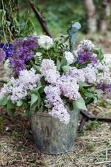 Celebratory Blooms: Lilac Peonies, Giant Onions, and Carnations in a Decorative Basket, Adorning Outdoor Events and Weddings with Fresh Floral Elegance. - 706327782