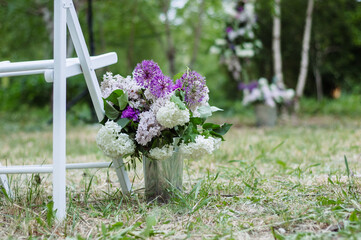 Celebration of Blooms: Lilac Peonies, Giant Onions, and Carnations in a Decorative Bucket, Adding Color to Outdoor Events and Weddings - 706327792