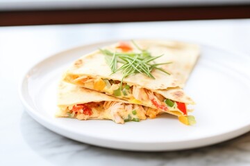 cheesy chicken quesadilla on a white plate