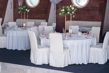 Cozy Wedding Reception: Elegantly Set Round Tables in a Restaurant Venue - 706329354