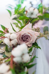 Flower arrangement close-up. Pink roses and white cotton flowers. Wedding day