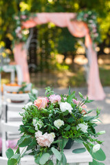 Bouquet of flowers against the backdrop of a wedding arch.
