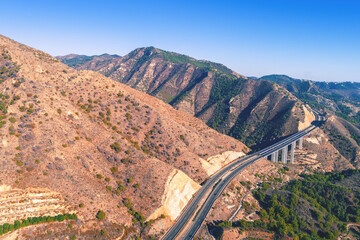 View from above Mountain landscape with viaduct. Honey Viaduct on Mediterranean Highway. Viaducto del Miel on Autovia del Mediterraneo. Malaga, Spain
