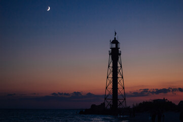 Lighthouse at sunset on the island of Dzharylgach, Ukraine. The legendary 24-meter Eiffel Lighthouse. - 706331510