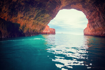 Coastal rocky seascape. Entrance in Benagil cave in Algarve region. Atlantic Ocean, Portugal, Europe