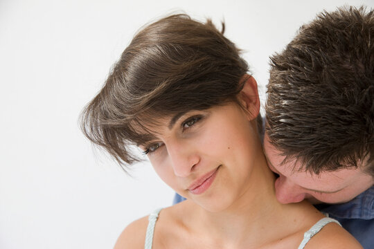 Man Kissing Back of Woman Neck
