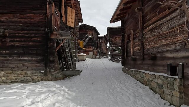 Bellwald, an old Swiss village in winter with snow. Old huts and cabins on the alp