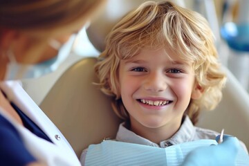 A smiling young blond boy in a dental chair. Examination by a dentist - obrazy, fototapety, plakaty