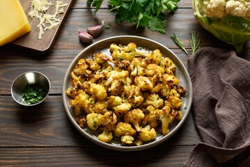 Roasted cauliflower on wooden background
