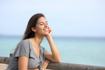 Happy woman enjoying a sunny day on the beach