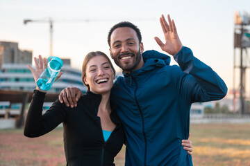  Happy, smiling, sporty friends ready to exercise or train with bottle of water in hand. an active...