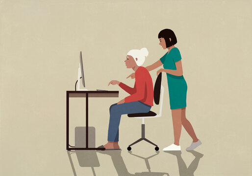 Granddaughter helping grandmother using computer
