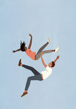 Couple falling midair against blue sky
